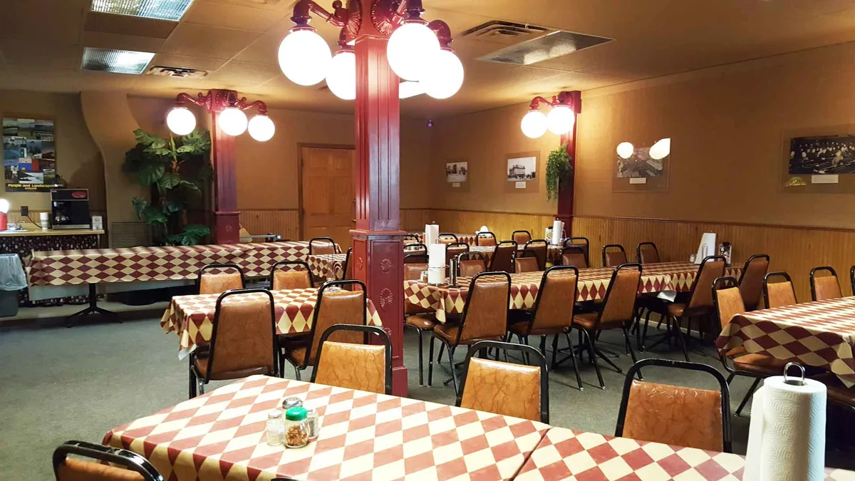 The Shamrock dining room, with wood chairs, tables and warm plaster walls